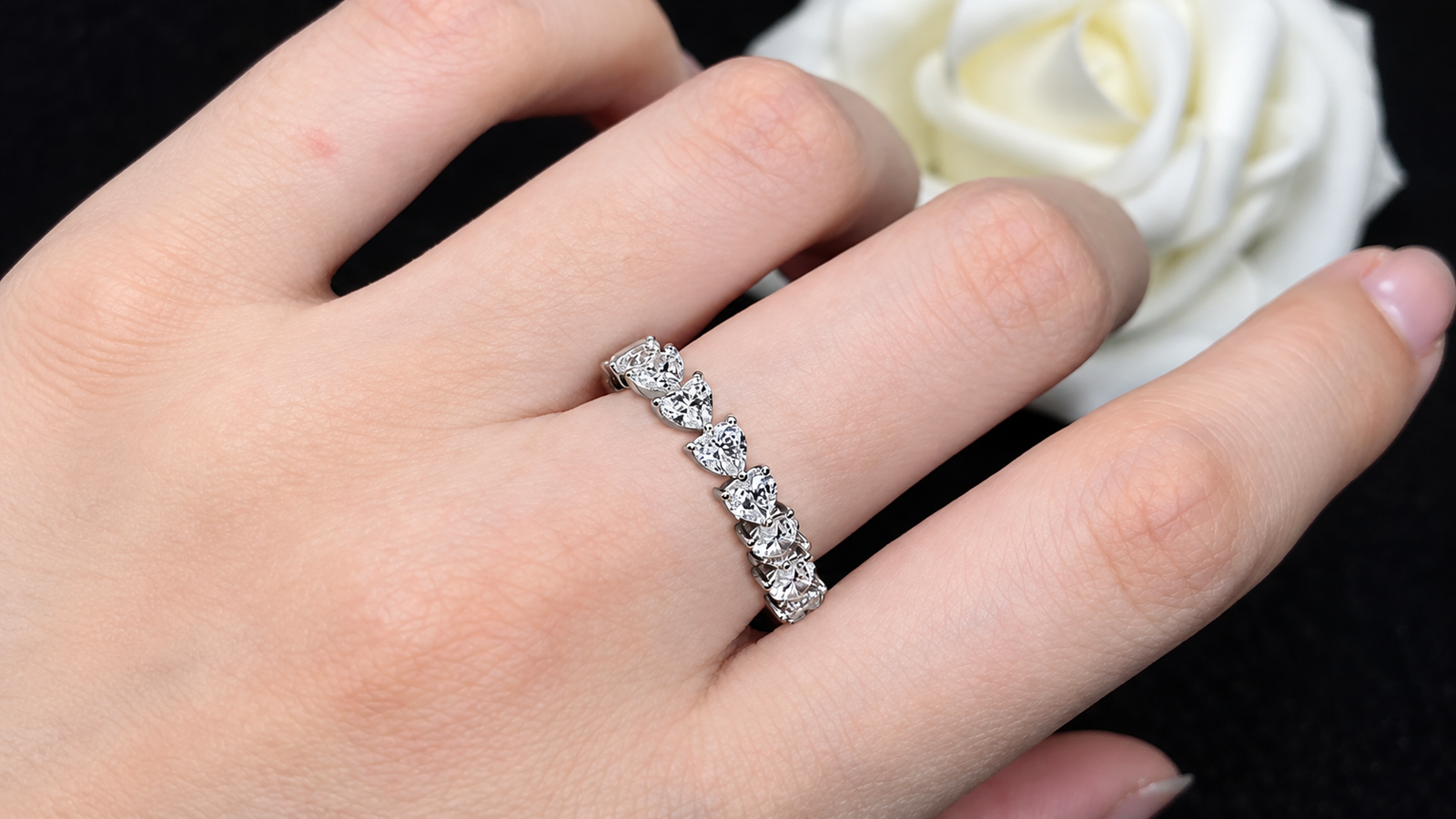 Hand wearing an elegant diamond ring, showcasing affordable luxury jewelry for everyday style.