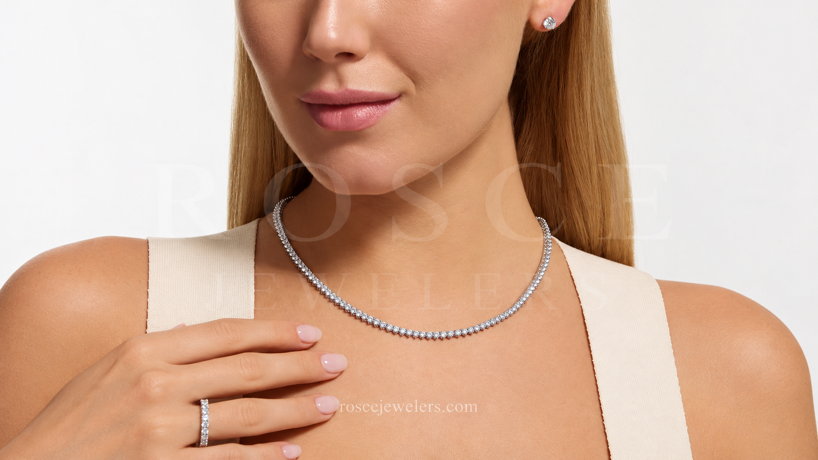 Close-up of a woman’s lower face and upper shoulder wearing a tennis bracelet, tennis necklace, and diamond earrings, showcasing affordable luxury jewelry.
