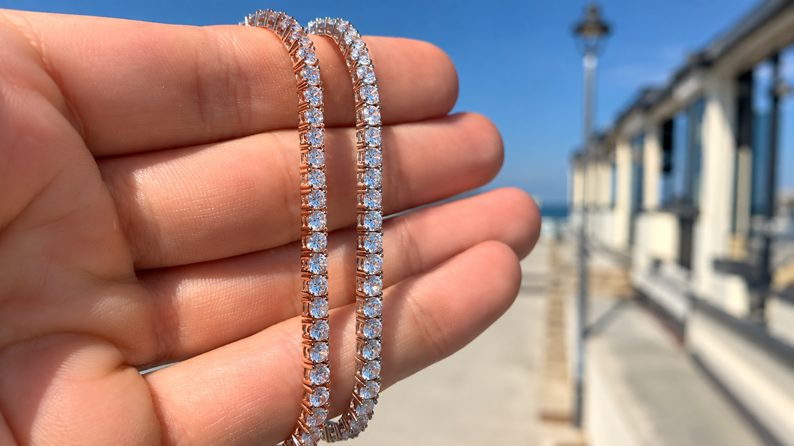 Hand showcasing two elegant tennis bracelets, highlighting affordable luxury jewelry for everyday wear.