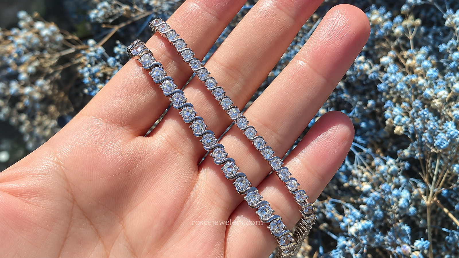 Hand showcasing elegant tennis bracelets, highlighting affordable luxury jewelry for everyday wear.